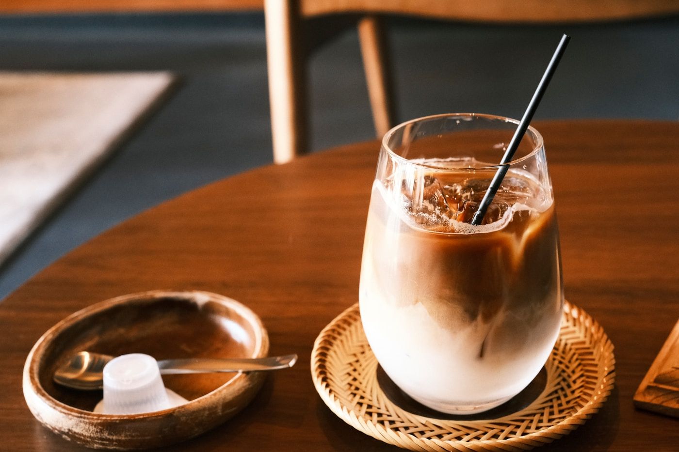 木のテーブルに置かれたアイスコーヒーのグラス
